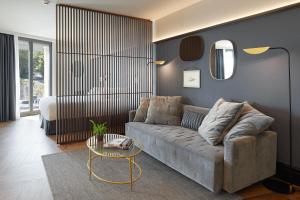 a living room with a couch and a table at Hotel SANSEbay in Donostia-San Sebastián