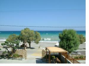 a view of the beach from the balcony of a resort at Almirikia Apartments in Mourteri