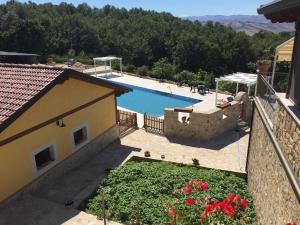 a view of a swimming pool from a house at Agriturismo La Dimora dei Cavalieri in Vaglio di Basilicata