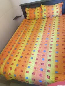 a bed with a colorful comforter and pillows at Victoria mobilehome in Village Residence Juliamare in Giulianova