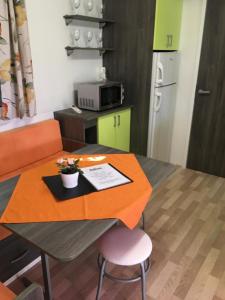 a kitchen with a table with an orange table cloth at Victoria mobilehome in Village Residence Juliamare in Giulianova