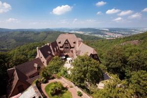 a large stone building with a view of mountains at Romantik Hotel auf der Wartburg in Eisenach