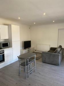 a living room with a table and a couch at The Bungalow in Leeds