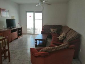 a living room with two couches and a tv at Apartment Los Eucaliptus in L'Eucaliptus