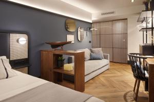 a living room with a couch and a table at Hotel SANSEbay in Donostia-San Sebastián