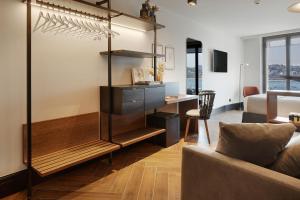 a living room with a couch and a desk at Hotel SANSEbay in Donostia-San Sebastián