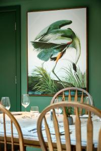 a dining room table with a picture of a bird at The Westleton Crown in Westleton