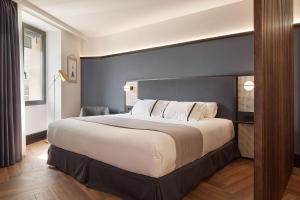 a bedroom with a large bed in a room at Hotel SANSEbay in Donostia-San Sebastián