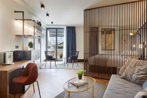 a living room with a couch and a table at Hotel SANSEbay in Donostia-San Sebastián