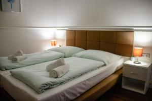 a large bed with two white pillows on it at G&H Hotel Rosengarten in Rosengarten