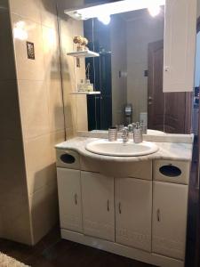 a bathroom with a sink and a mirror at Apartment in Most City, center in Dnipro