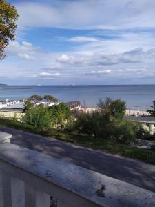 a view of the beach and the ocean from a building at Apartament Bogoslovovi in Varna City