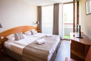 Postel nebo postele na pokoji v ubytování Hotel Orion Várkert