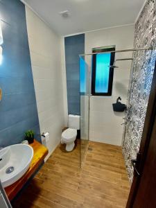 a bathroom with a toilet and a sink at Sea You Guest House in Ezerets