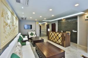 a living room with a couch and a table at Hotel Fun Residency by Antra Group in Ahmedabad