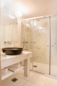 a bathroom with a sink and a shower at Rhodos Horizon Blu-Adults Only in Rhodes Town