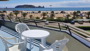 a table and chairs on a balcony overlooking the beach at A. Garganta - Rocamaura & Catalonia in L'Estartit