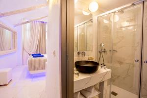 a bathroom with a sink and a glass shower at Rhodos Horizon Blu-Adults Only in Rhodes Town