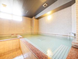 a large pool of water in a room at Hotel Premium Green Sovereign in Sendai