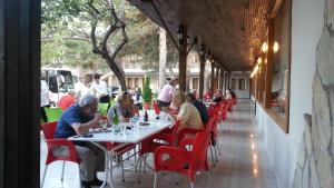 a group of people sitting at tables in a restaurant at Hotel Aşıkoğlu in Bogazkale