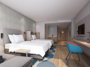 Postel nebo postele na pokoji v ubytování Holiday Inn Express Shenzhen Haiyuan City by IHG