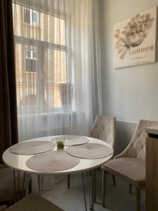 a living room with a table and chairs at Homelike Apartment in Lviv