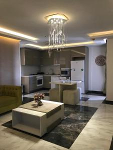 a living room with a table and a kitchen at Aquamarine Luxury Residence in Kyrenia