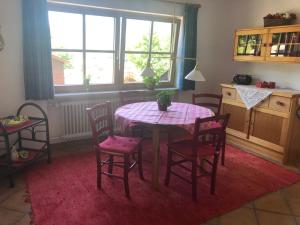 a table and chairs in a kitchen with a table and windows at Ferienwohnungen Oberau in Berchtesgaden