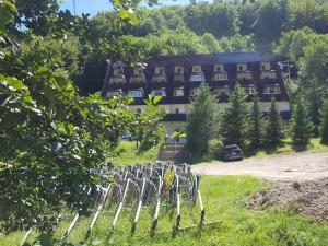 a fence in front of a building in a field at Košuta 21 Center Duplex Apartment, Brzeće in Brzeće