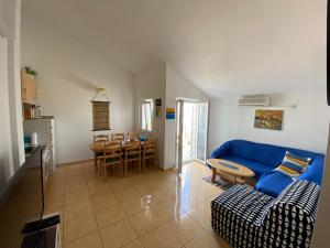 a living room with a blue couch and a table at The View in Supetar