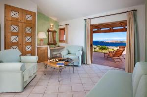 a living room with a view of the ocean at Hotel Relax Torreruja Thalasso & Spa in Isola Rossa