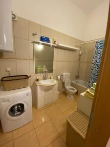 a bathroom with a washing machine and a washer at The View in Supetar +50 photos