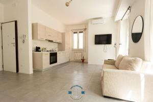 a living room with a couch and a kitchen at Appartamento Lotito Loft in Lido di Ostia