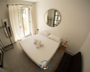 a large bed in a room with a mirror at Appartamento Lotito Loft in Lido di Ostia