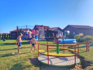 a group of children playing on a playground at Domek Standard 2 in Darłowo