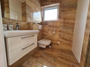 a bathroom with a sink and a toilet at Penthouse apartmán s terasou - rezidencia Minerál in Bardejovské Kúpele +36 photos