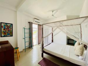 a bedroom with a bunk bed and a desk at Bliss Apartment Hikkaduwa in Hikkaduwa