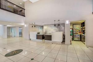 a lobby of a store with white walls and tile floors at La Quinta by Wyndham Modesto Salida in Modesto