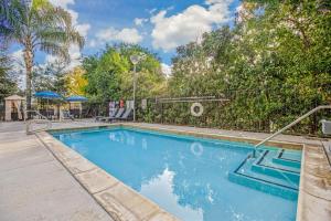 a swimming pool in a yard with trees at La Quinta by Wyndham Modesto Salida in Modesto