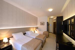 Postel nebo postele na pokoji v ubytování Hotel Majdan