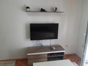 a living room with a flat screen tv on a wall at Apartman Lipa in Bar