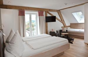 a bedroom with a bed and a large window at Pension Kramer in Grafenhausen