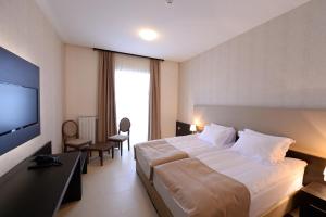 Postel nebo postele na pokoji v ubytování Hotel Majdan