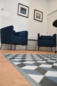 two blue chairs in a room with a checkered floor at HOTEL S - ALOJAMENTO LOCAL in Castro Verde