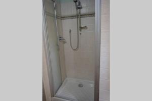 a shower with a glass door in a bathroom at Casa Furielli in Radda in Chianti +14 photos