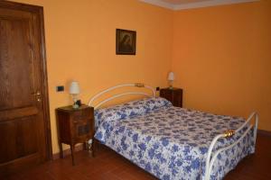 a bedroom with a bed and a wooden door at Casa Furielli in Radda in Chianti