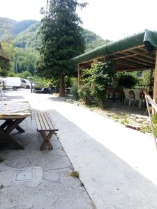a picnic table and a pavilion with a table and chairs at B&B ca'del grillo in Castel del Rio