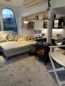 ein Wohnzimmer mit einem Sofa und einem Kamin in der Unterkunft Swamp Fox luxury 2BR Dutch Barge in Goolwa