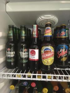 a refrigerator filled with lots of bottles of beer at Dodoma Siesta Inn in Dodoma