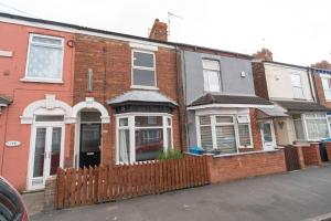 a red brick house with a wooden fence at 3 Bedroom Hull Sleeps 6 Glam Contractor & Leisure & Families Close to Clough Rd in Hull